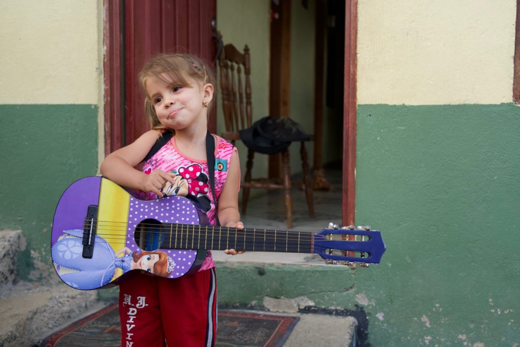 Yalena holds her princess guitar — something Monica would not have been able to give her before sponsors began supporting her. 