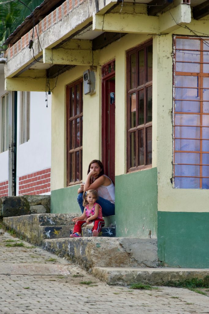 Monica and Yalena sip on their front stoop in the small, lakeside village where they live in southwestern Colombia. In the late 80s and 90s, Darien was one of the most dangerous places in Colombia. 