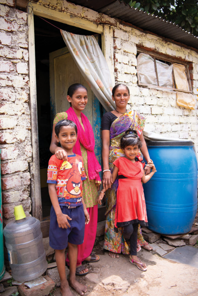 Family outside of their home in Pune, India