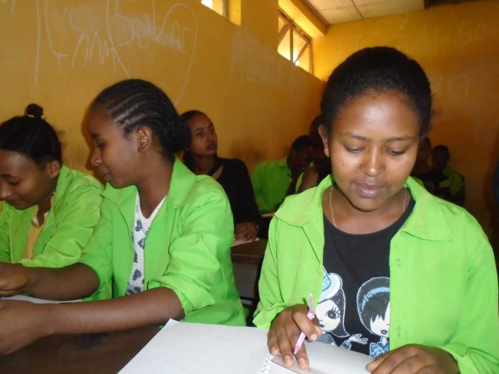 Today, thanks to help and encouragement from her Holt sponsor, Mekdes is able to attend school and dreams of becoming a doctor one day. Picture of Mekdes working with other students in school.