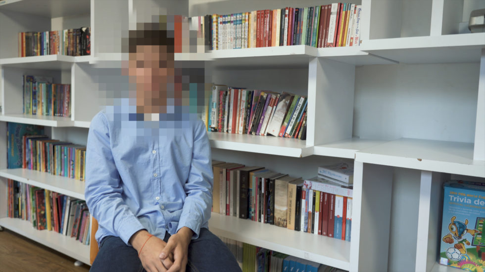 Fourteen-year-old Julian sits for an on-camera interview at Casa Imagina. We blurred his face to protect his identity.