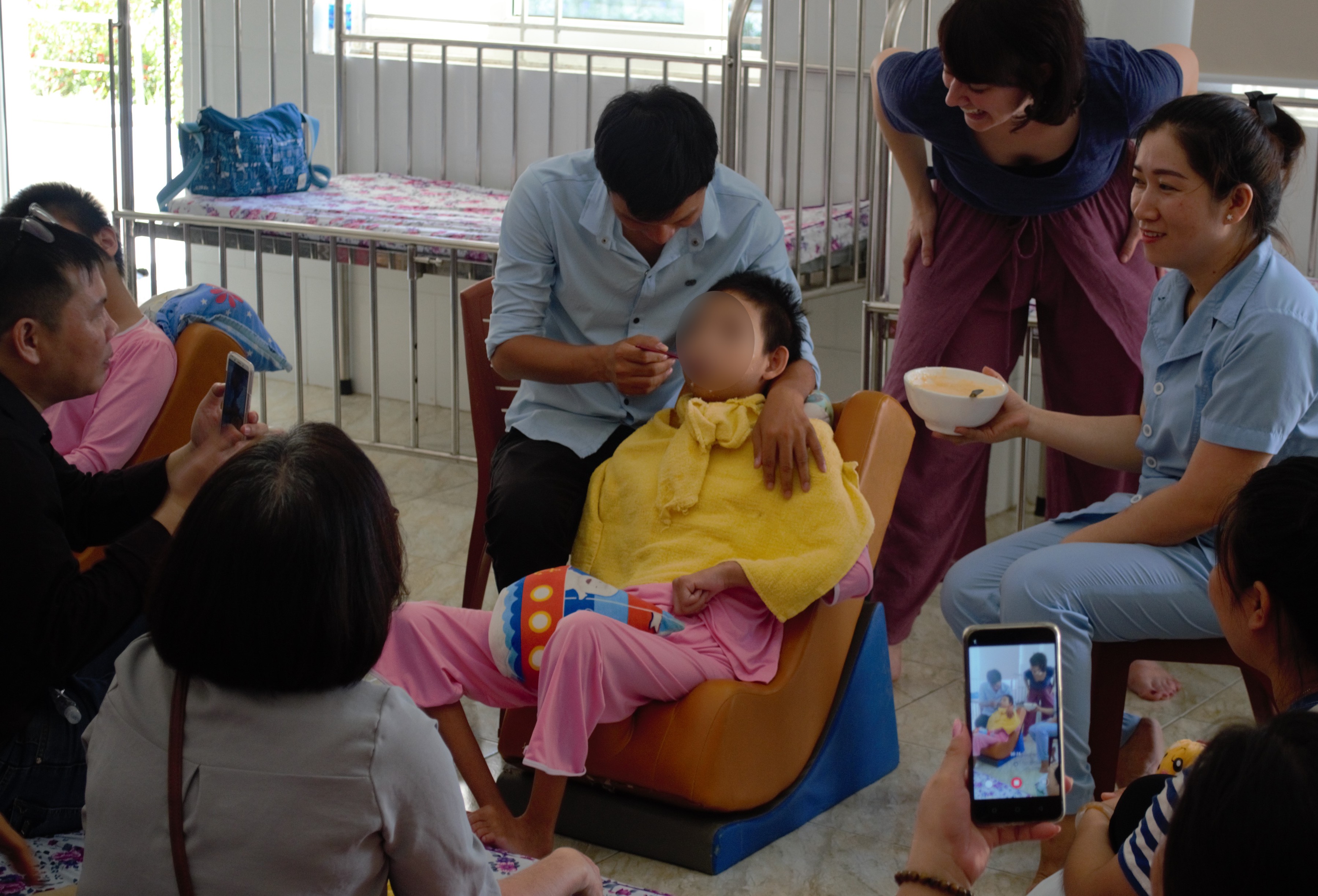 A child with cerebral palsy in Vietnam eats in a semi-reclined position, a new and much safer way for him to eat!