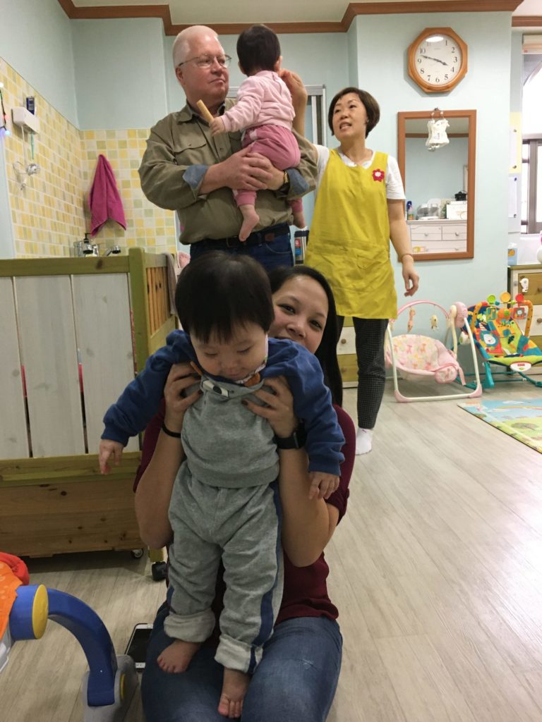 Gift team members play with children on a visit to one of Holt's programs in Korea. 