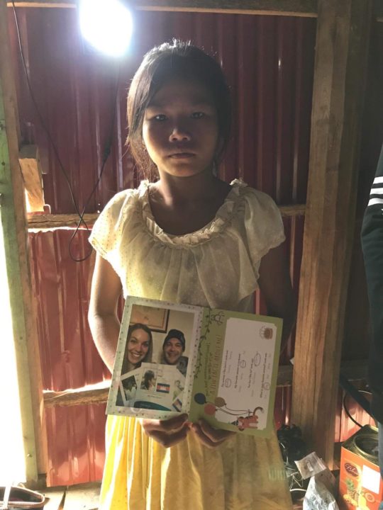 Phal holds a card she received from her sponsor, Billie. 
