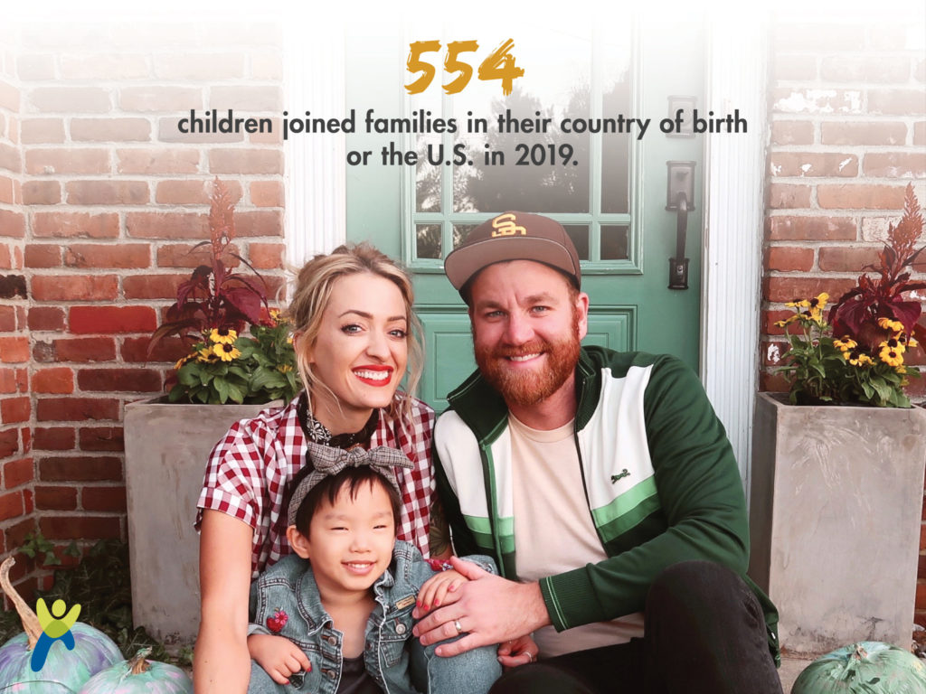 Mother father and adoptive child sitting on a home porch smiling_ graphic shows 554 children joined families in their country of birth or the US in 2019