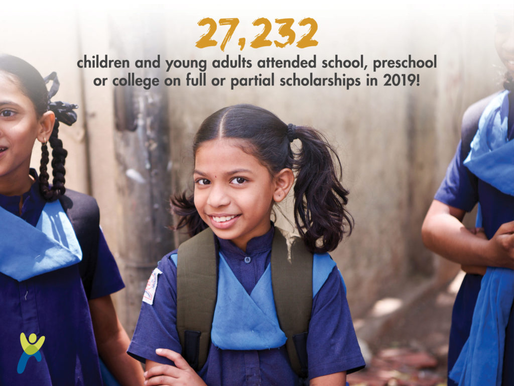 Girl standing with her hands crossed in front and two children standing to the side all dressed in uniforms_graphic says 27,232 children and young adults attended school preschool or college on full or partial scholarships in 2019
