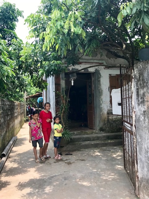 The children the Poliakoffs helped stand in front of their former home. 