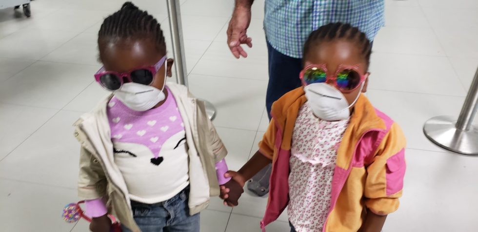 Gracie, left, and another little girl traveling to join their families in the U.S.