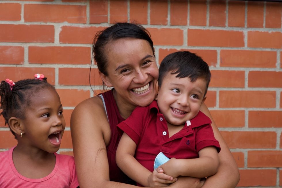 Johanna, one of the moms in the personal development program, holds her son at the end of another day of sponsor-supported daycare. 