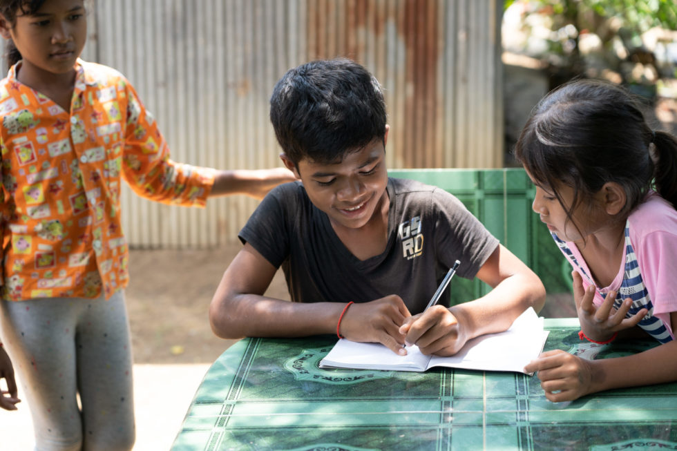 Kea learned to read and write in the orphanage. Now that he has a sponsor, he can still attend school while living with his grandma and sisters.