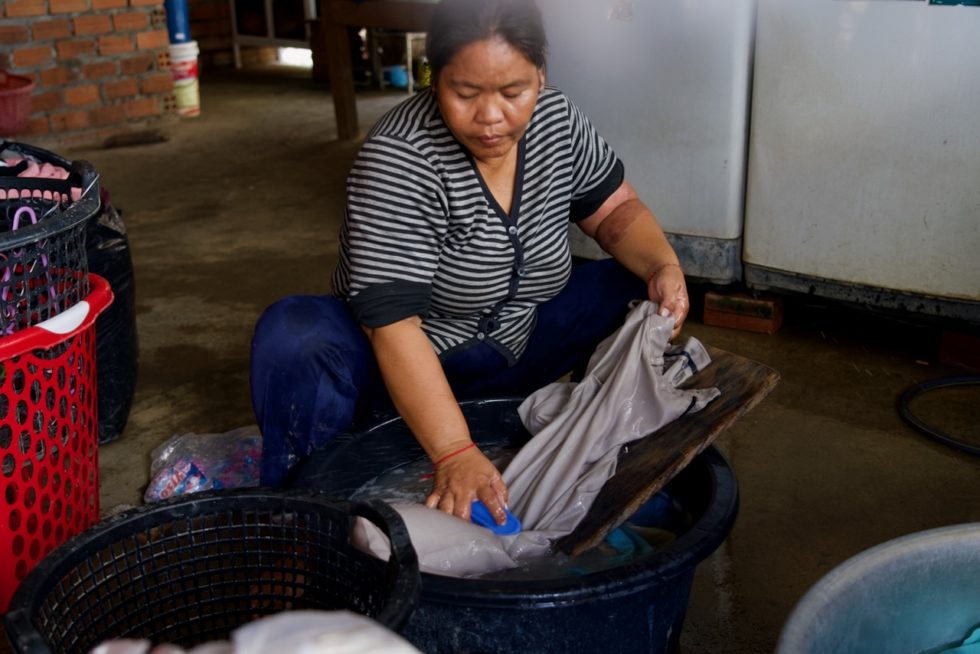 Ary washes clothes.