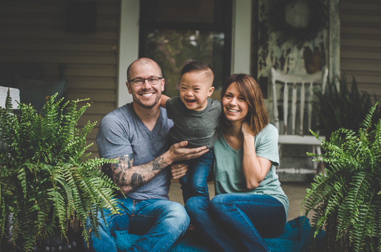 Adopted family outside home on front poorch