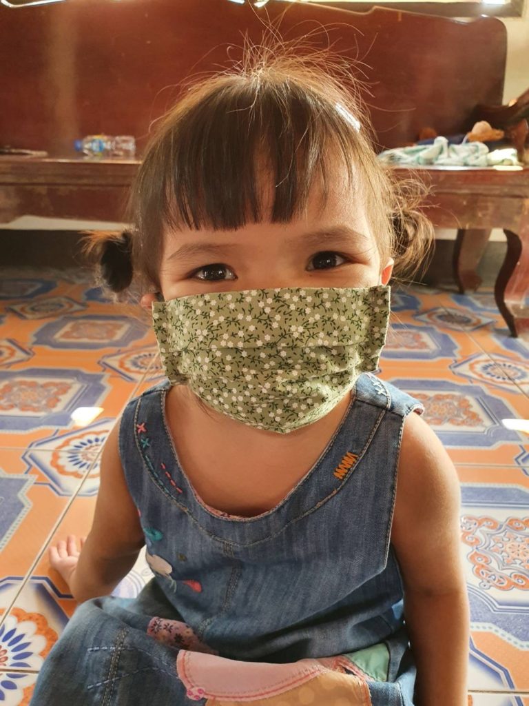 little girl in green mask