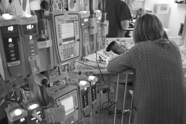 Adoptive mom Andrea at her daughter Scarlett's bedside after her heart operation. 