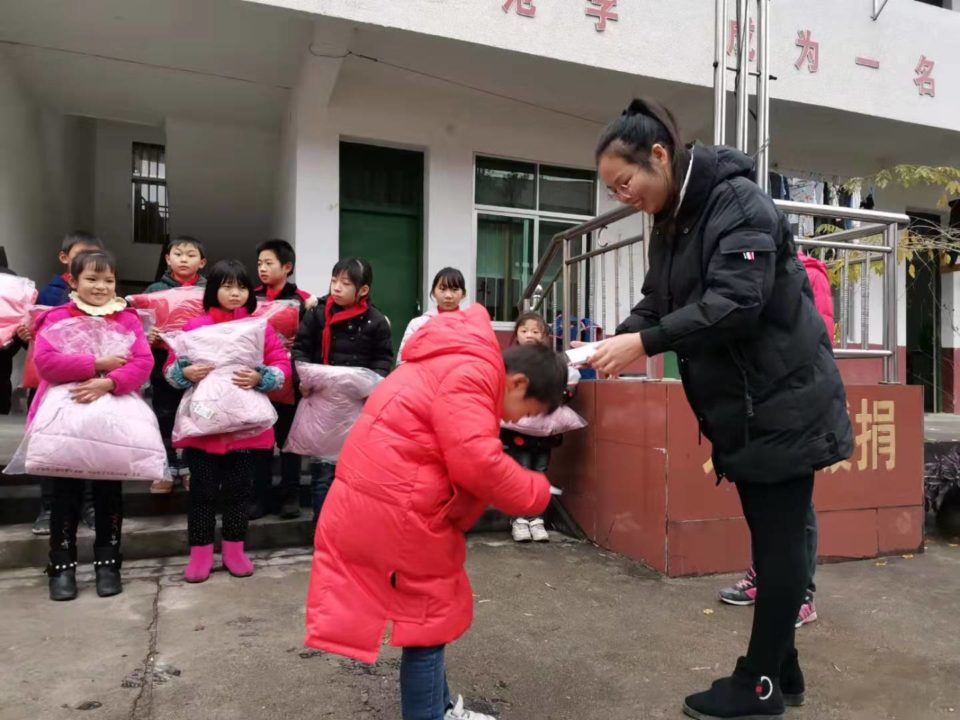Local staff distribute winter coats for children in China!