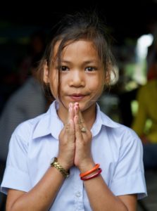 Sreyka holds her hands together palm to palm, a traditional way to say thank you in Cambodia. 