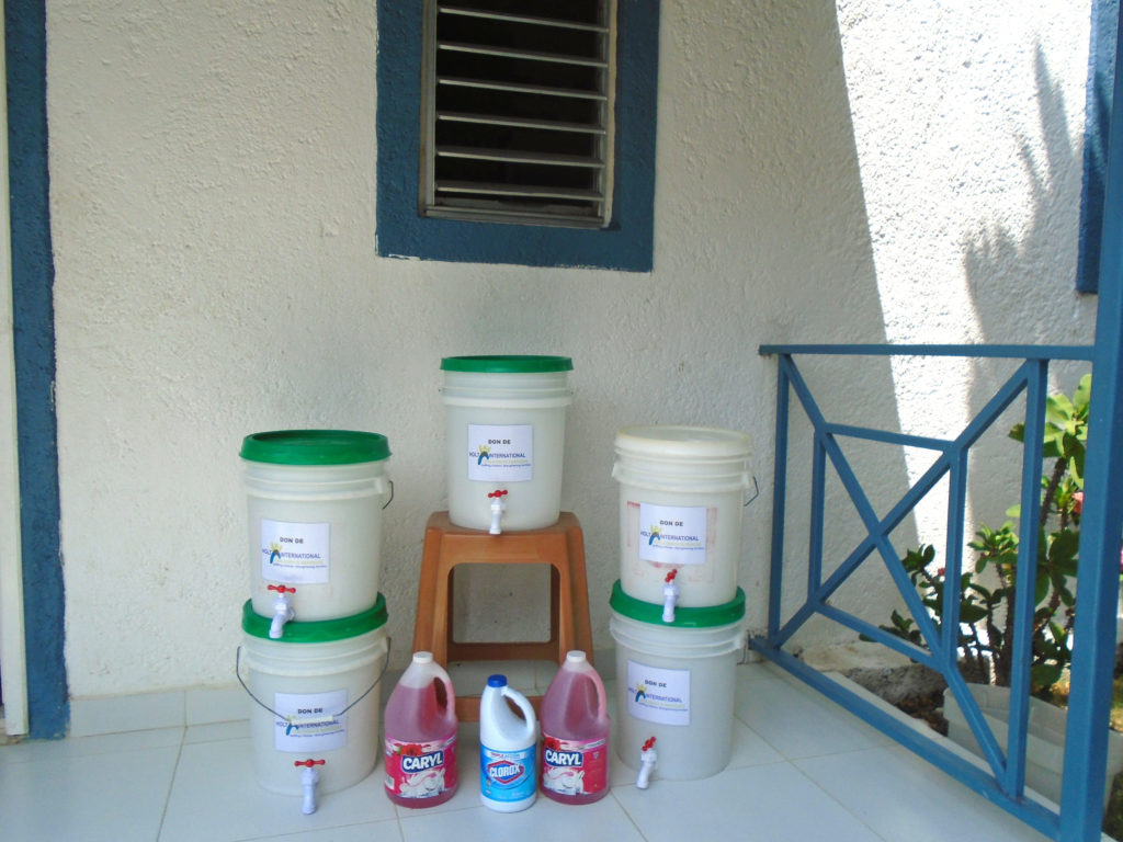 five plastic buckets of sanitizer and cleaner