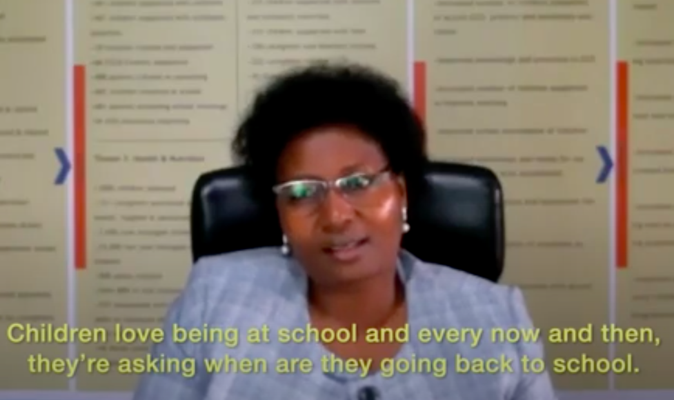woman in glasses saying "children love being at school every now and then"