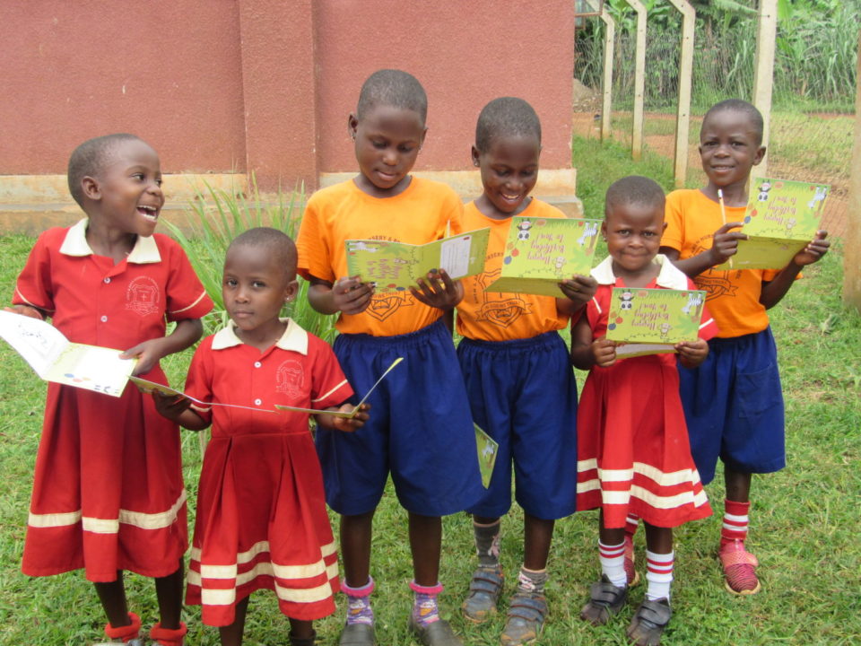 Children in Holt's child sponsorship program in Uganda hold cards from their sponsors in celebration of International Day of the Child! 