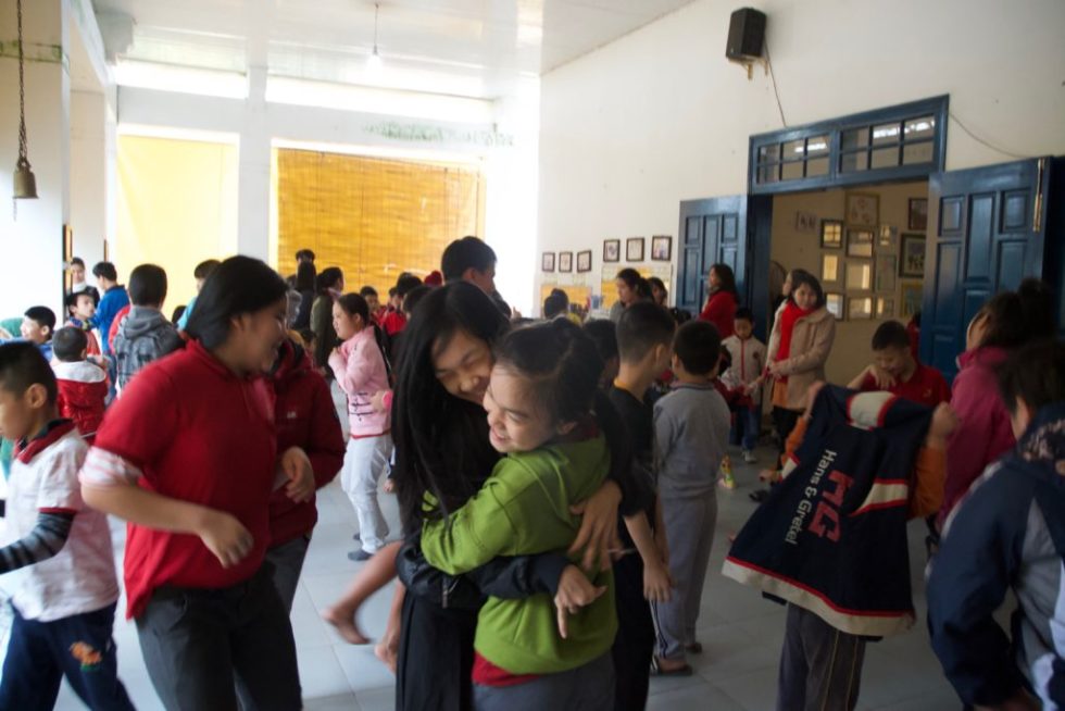  Kianh students give each other a playful hug during their school’s weekly Friday afternoon dance party!