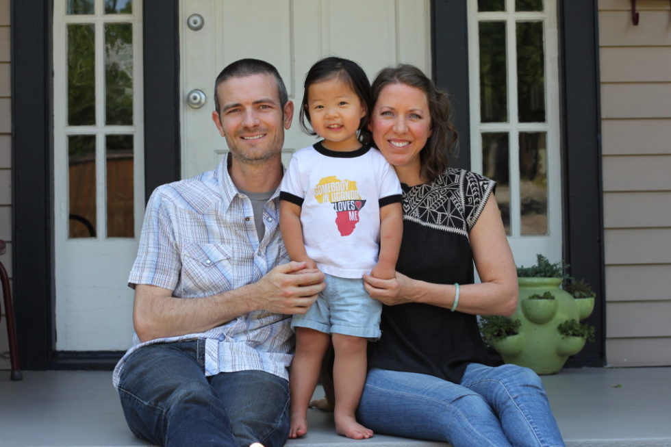 Kevin and Sarah Brown with daughter Julia sitting on front porch