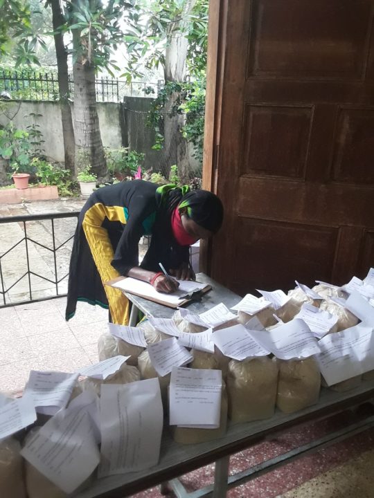 A staff member prepares a distribution of immunity boosters for children in sponsorship. 