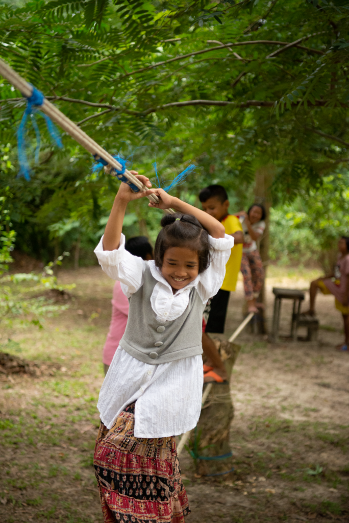 girl walking on balancing rope bridge