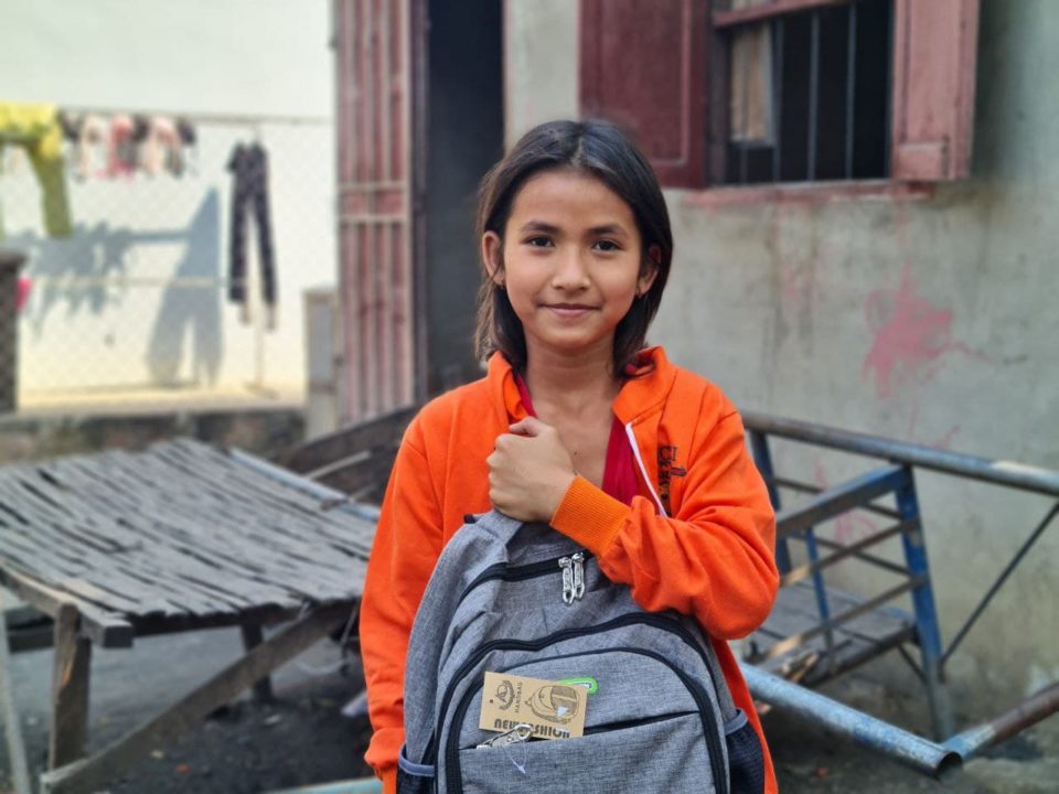 A girl in Holt sponsorship holds the new backpack her sponsors gave her for the school year. 