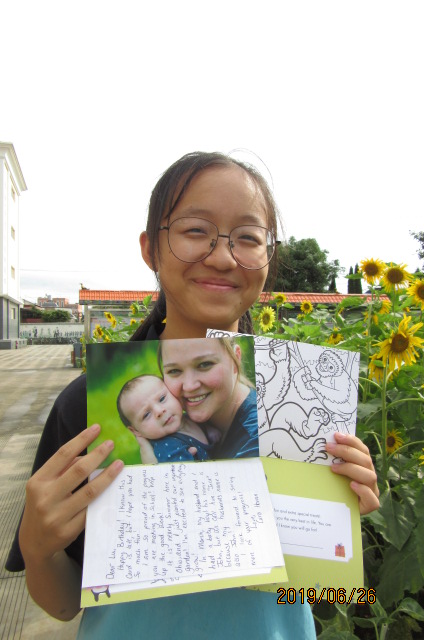 teenage girl smiling holding birthday card