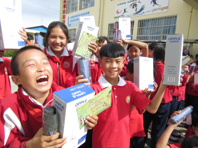 group of laughing children holding presents