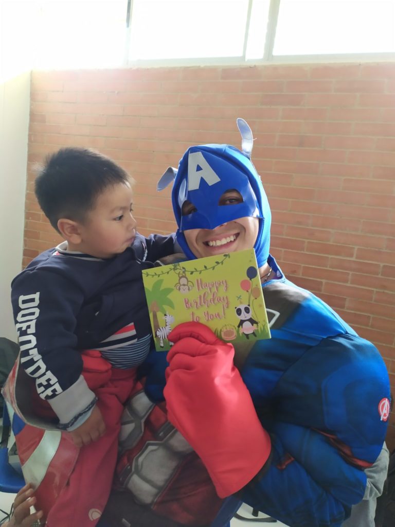 little boy with man dressed as a superhero