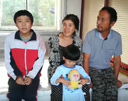 Thao (center) with her family after Holt donors and Holt staff in China helped them overcome their challenges. 