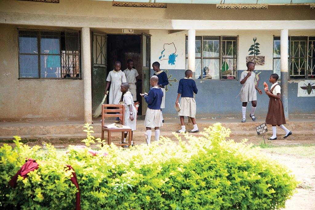 children talking and playing outside in school uniforms