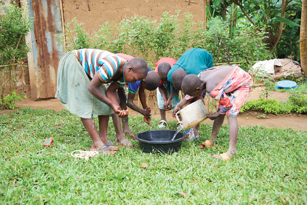 five children washing in a basin of water
