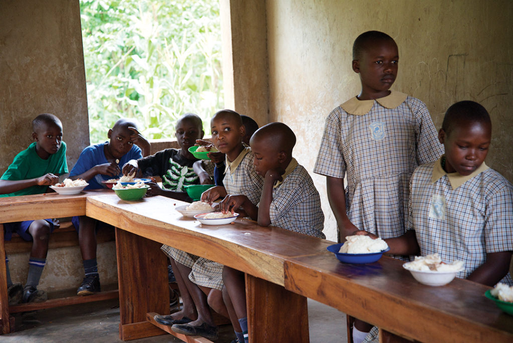 children sitting at a long desk