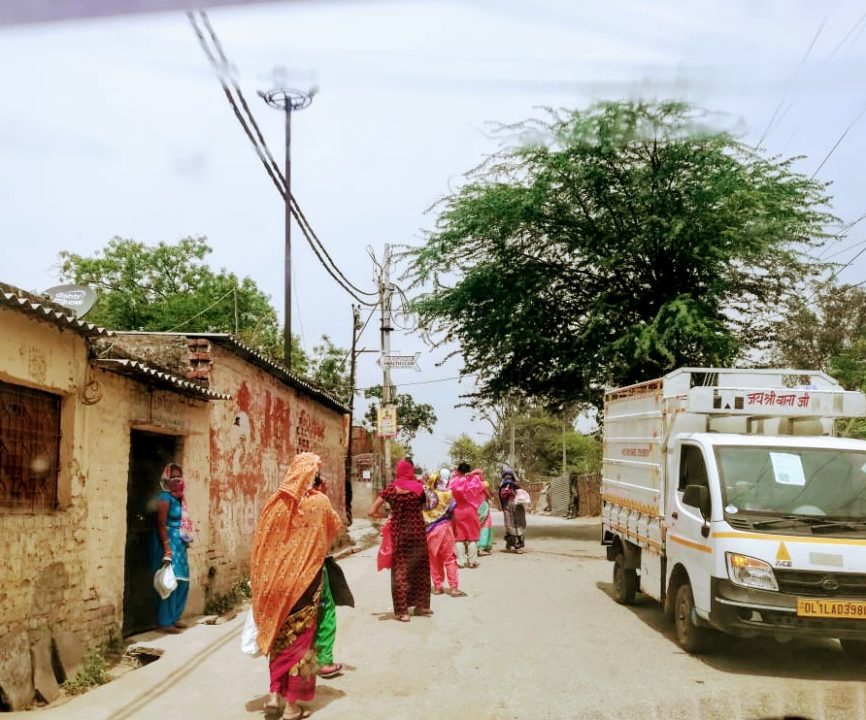 People wait in line for government food rations in Delhi. To help families meet essential needs like paying rent and bills, Holt partner SSG started provided direct cash transfers during the pandemic.