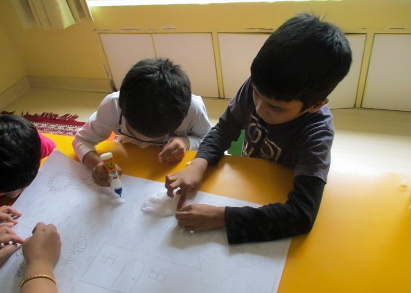 two boys coloring a picture