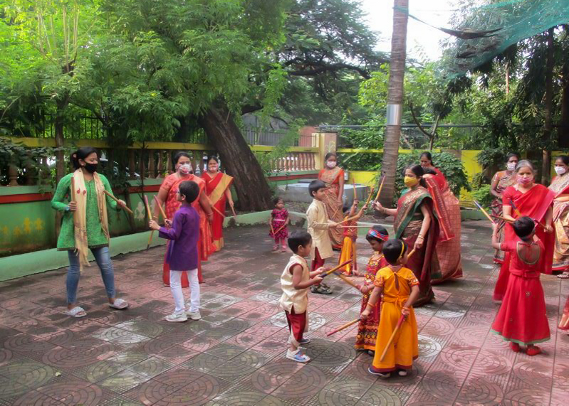 children doing the stick dance on navratri
