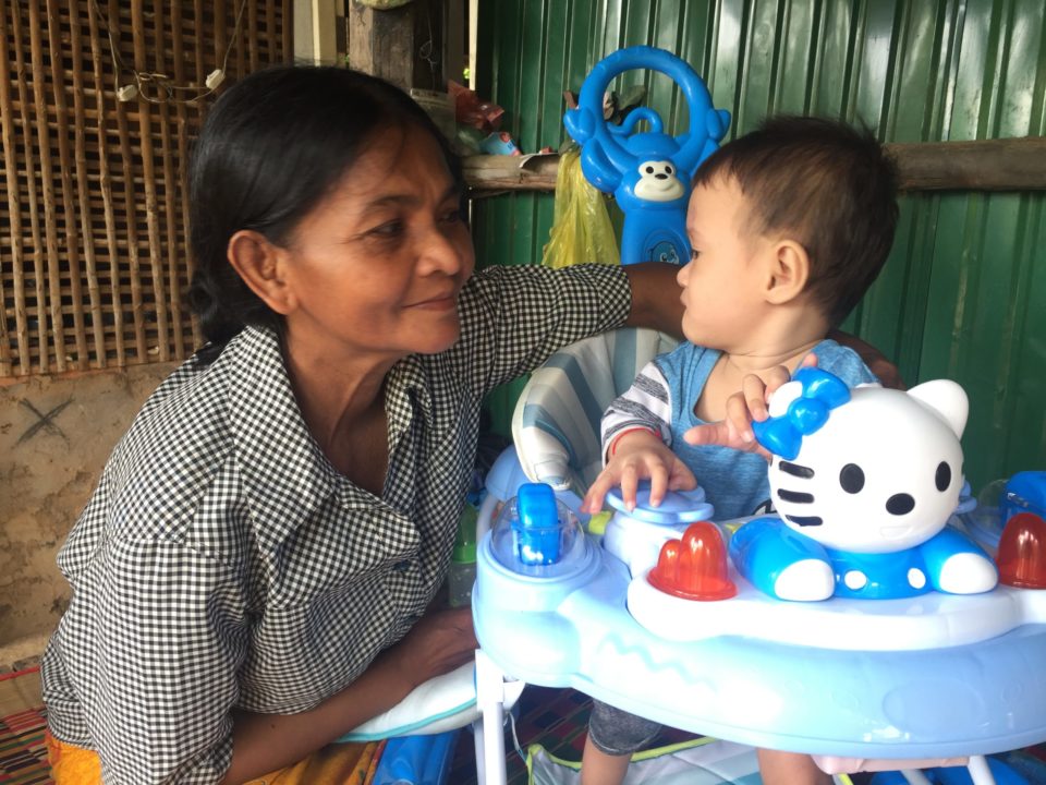 A child with his Holt-trained foster mom in Cambodia. 