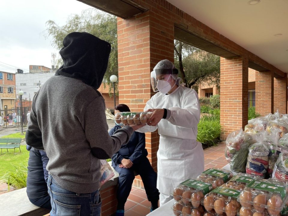 During COVID-19 in Colombia, a Holt partner distributes groceries to families in need.