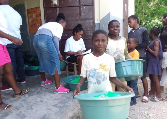 Haitian children moving supplies after earthquake 