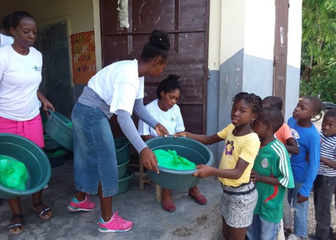 People charring supplies after earthquake in Haiti 