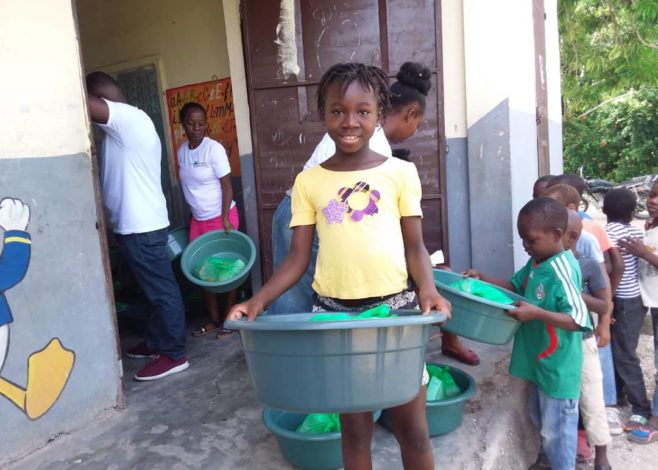 Gril helping move supplies after earthquake in Haiti 