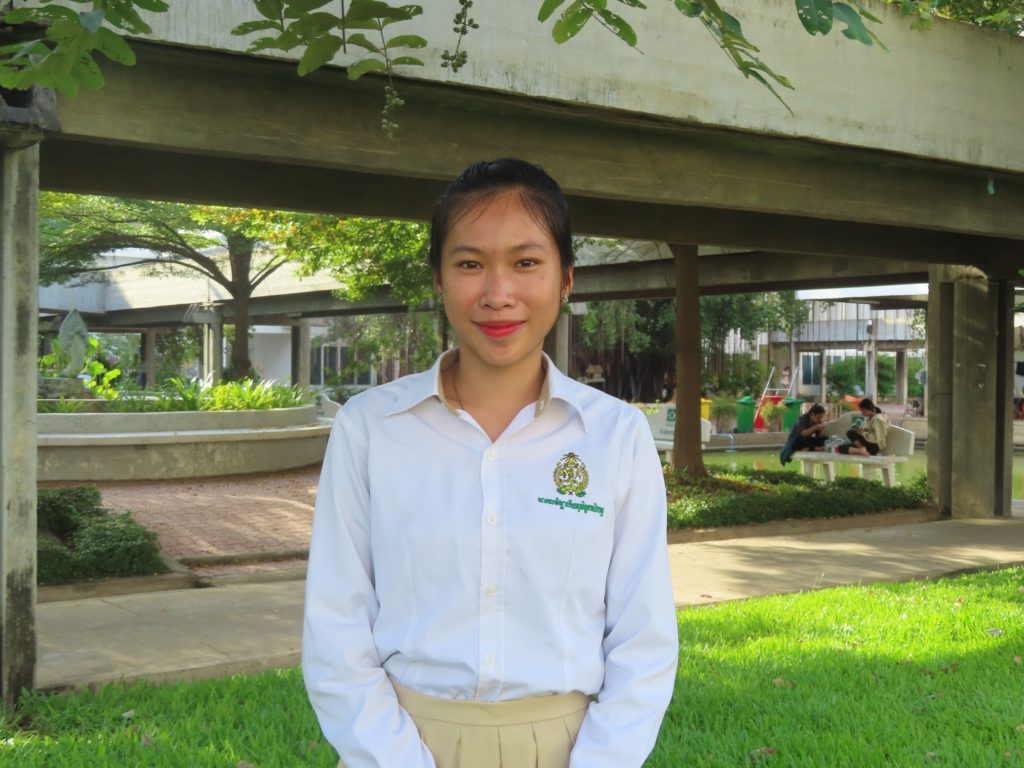 girl in university uniform smiling at camera