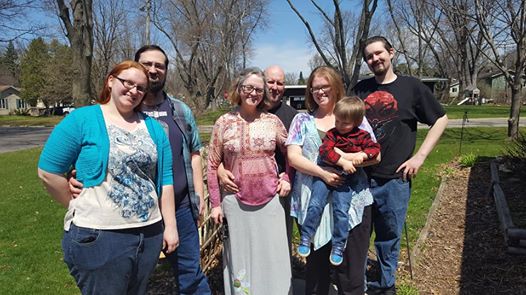 group of smiling people at a park
