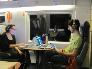 man and woman sitting across from each other working on laptops