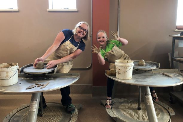 mom and daughter using potter's wheels