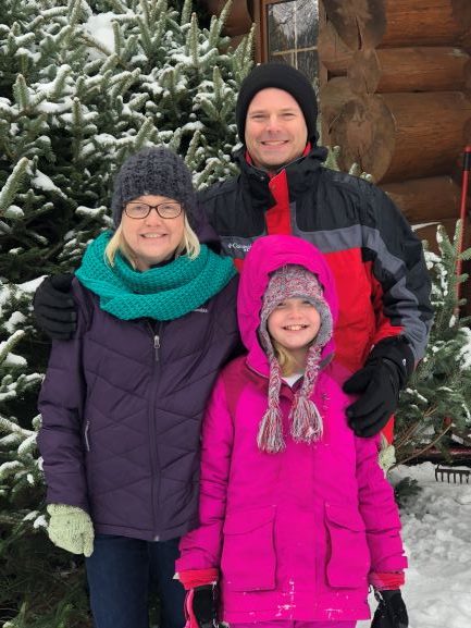 dad mom and daughter at christmas tree farm