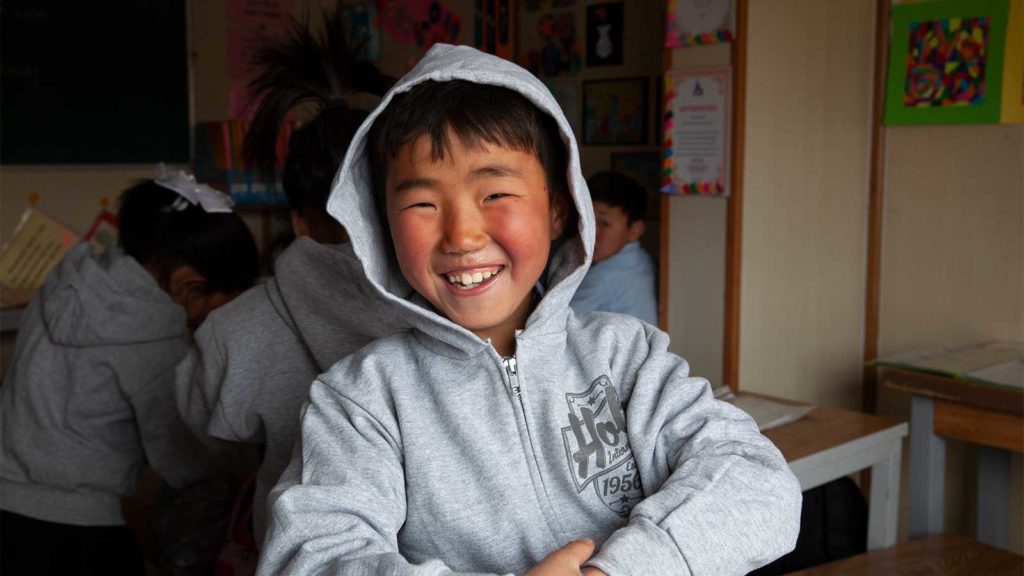 Mongolian boy smiles for camera
