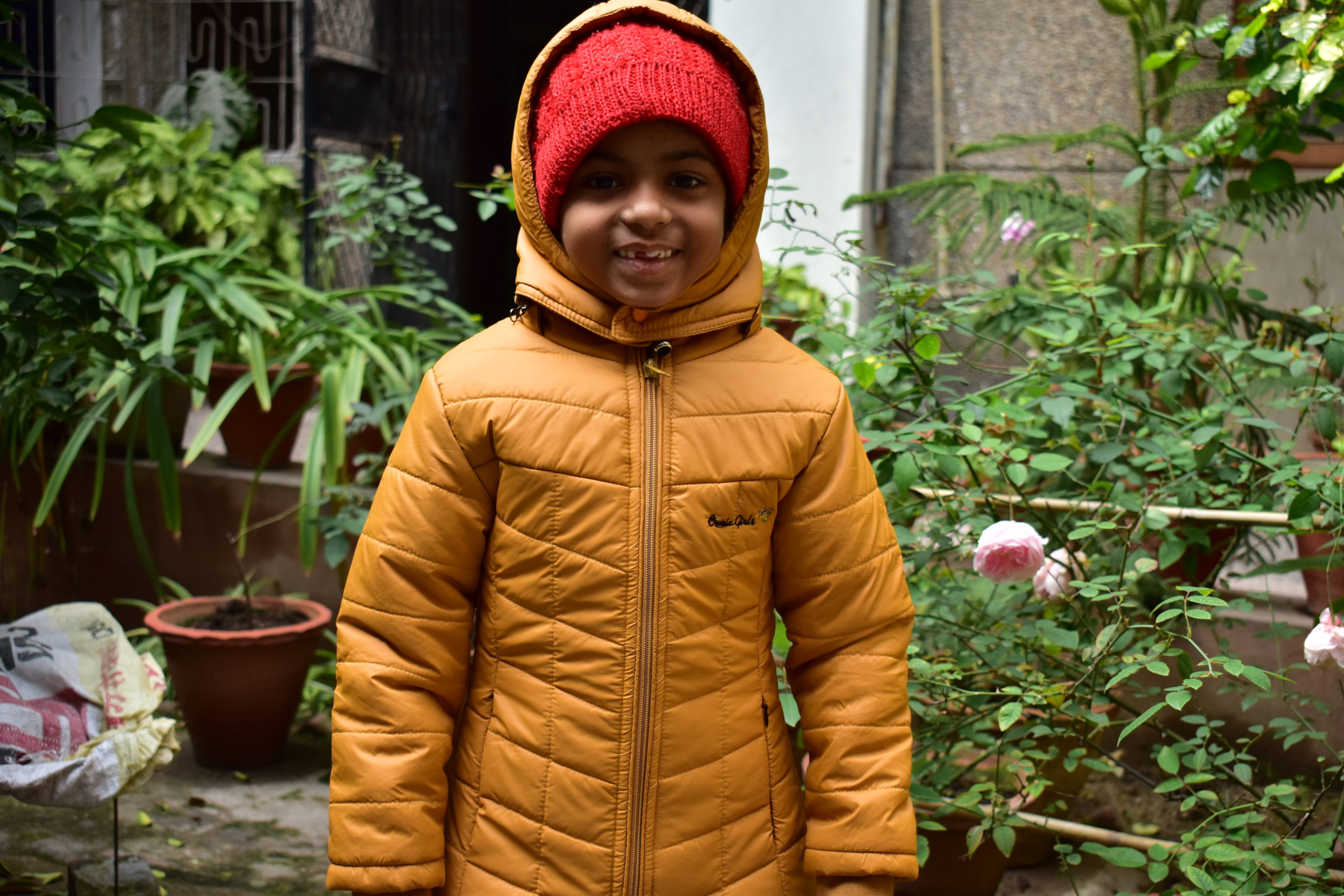 boy in yellow puffy coat and red beanie